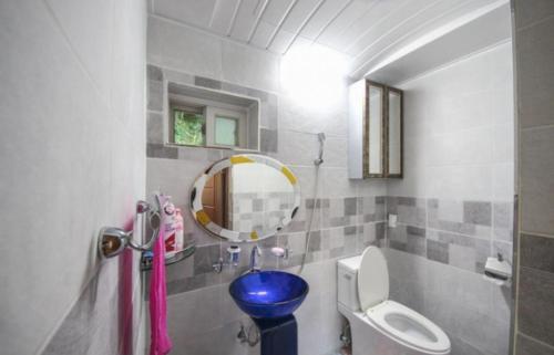 a bathroom with a toilet and a mirror at Doyosae Hanok Pension in Suncheon