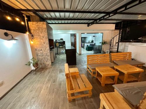 a restaurant with wooden tables and benches in a room at Morada Apartamentos in Tacna