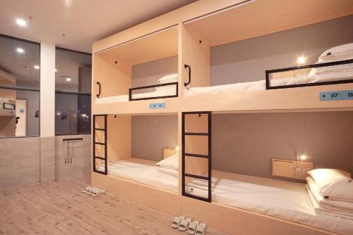 a room with four bunk beds in it at Swan's Journey International Youth Hostel - Changsha Wuyi Square IFS IFC in Changsha