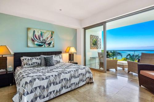 a bedroom with a bed and a view of the ocean at Amapas ocean view condo in Puerto Vallarta