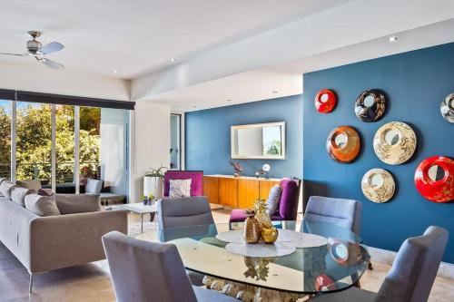 a living room with blue walls and a table and chairs at Amapas ocean view condo in Puerto Vallarta