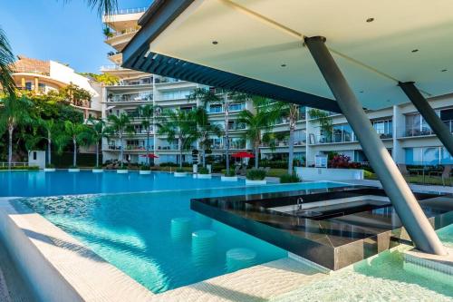 an infinity pool in front of a building at Amapas ocean view condo in Puerto Vallarta