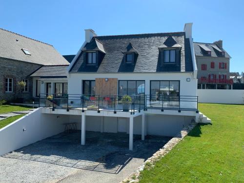 a large house with a balcony on the side of it at Maison d'exception ~ Vue Mer ~ 100m de la plage in Camaret-sur-Mer