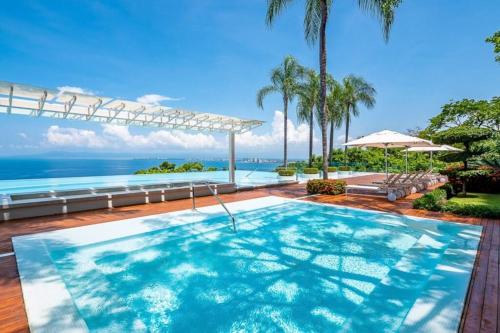 a swimming pool with a view of the ocean at Free Transport ~OCEAN VIEWS~ Romantic zone in Puerto Vallarta