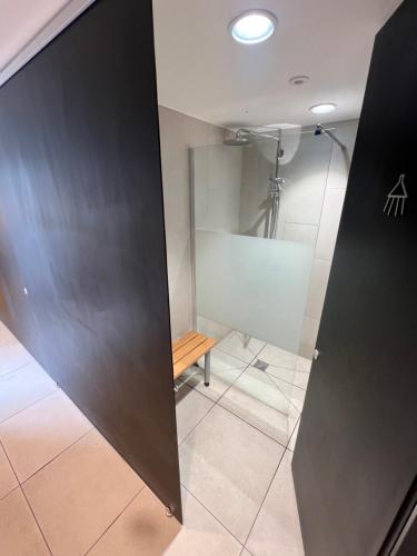 a bathroom with a shower and a glass door at SUPERYACHT ON TOWN QUAY MARINA, SOUTHAMPTON - Very close to city centre and cruise terminals - free parking included in Southampton