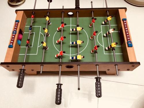 a game board with miniature people playing soccer at TainanHyggeAnping in Tainan