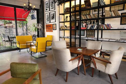 a restaurant with chairs and a table in a room at THE 1O1 Bali Fontana Seminyak in Legian