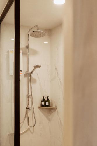 a shower with a shower head in a bathroom at RUS Hotel&Convention Ayutthaya in Phra Nakhon Si Ayutthaya