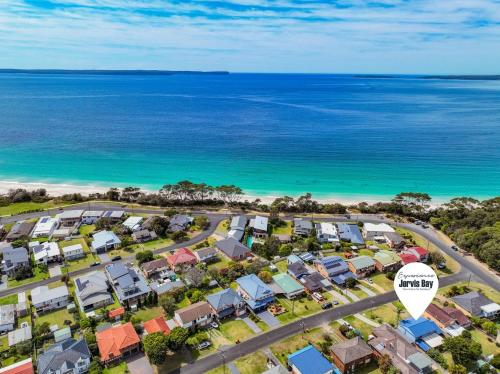 an overhead view of a residential suburb next to the ocean at Benjos by Experience Jervis Bay in Vincentia