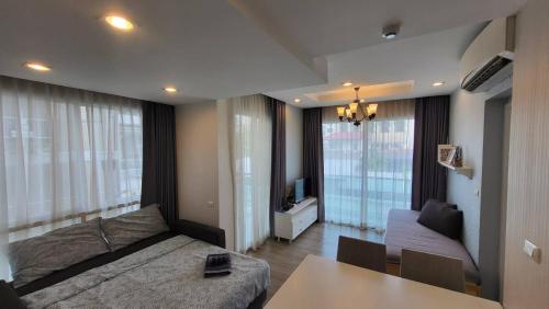 a living room with a couch and a table at The Blu X Condo Bangsean R9 in Ban Bang Saen (1)