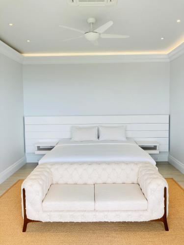 a white bed in a white room with a white couch at Highend Private Pool Villa in Taling Ngam Beach
