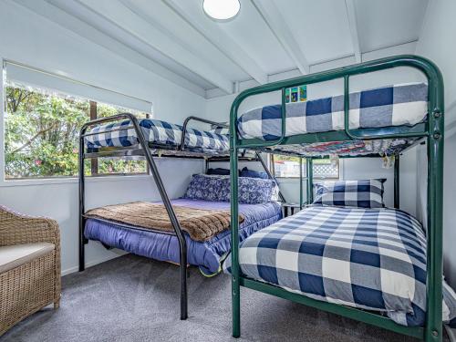 two bunk beds in a room with a window at Our Happy Place - Kinloch Holiday Home in Kinloch
