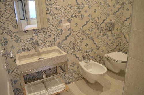 a bathroom with a sink and a toilet at Villa Quisisana Taormina in Taormina