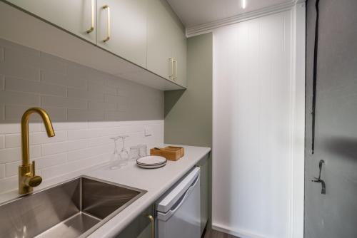 a small kitchen with a sink and a sinkiterator at Townsville Eco Resort 
