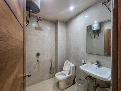 a bathroom with a toilet and a sink at Hotel AMBE INN By Ambience Delhi IGI Airport in New Delhi