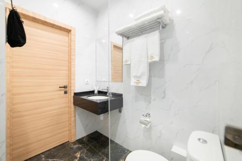a bathroom with a toilet and a sink at Freedom hotel Bishkek in Bishkek
