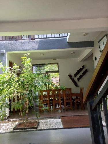 a living room with a dining room table and chairs at Gampaha Heritage in Gampaha
