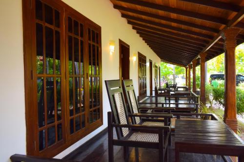 a row of tables and chairs on a patio at Hotel Green Garden in Trincomalee