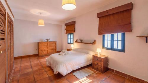 1 dormitorio con 1 cama, 2 vestidores y ventanas en Casa Rural Aguasal El Bosque by Ruralidays, en El Bosque