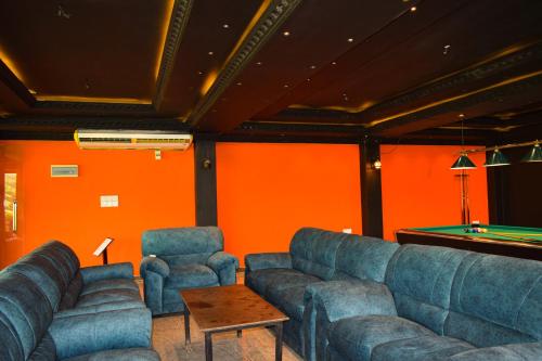 a living room with couches and a pool table at Hotel Green Garden in Trincomalee