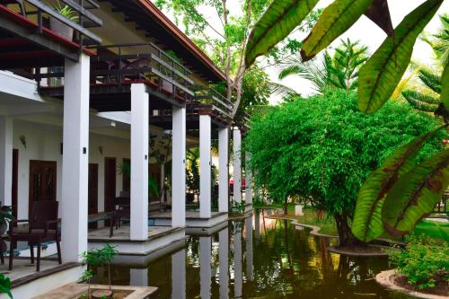 a courtyard of a building with water in front of it at Hotel Green Garden in Trincomalee