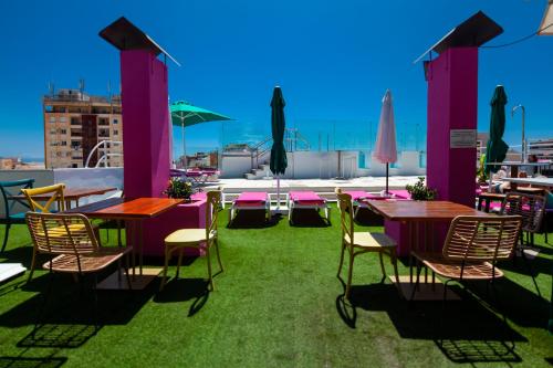 a group of tables and chairs on a roof at Hotel Sireno Torremolinos - Adults Only, Ritual Friendly in Torremolinos