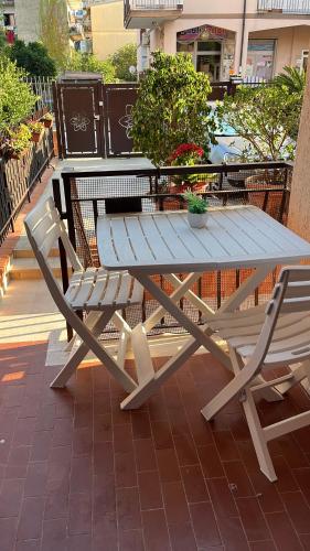 a picnic table and two chairs on a patio at Stefy's House in Scalea