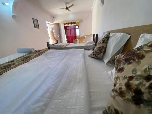 a large white bed in a room with a bedroom at Mariyan Desert Safari Camp in Sām