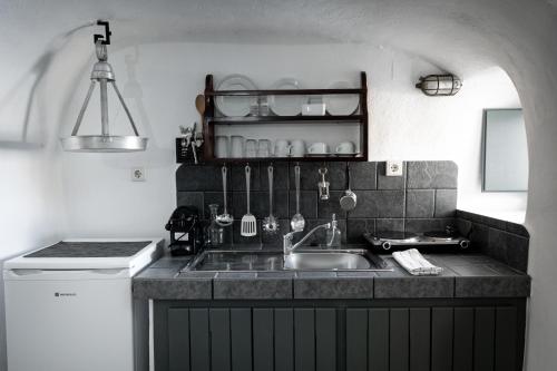 a kitchen with a sink and a counter top at Lotza Studios in Oia