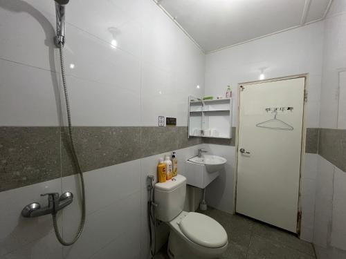 a bathroom with a toilet and a shower and a sink at Joyful homestay Miri in Miri