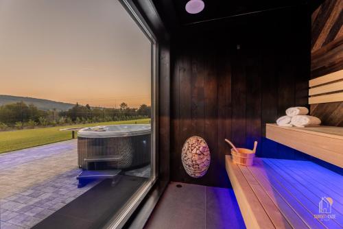 a sauna with a view of a golfournament from a window at Sunset House & Spa in Ustrzyki Dolne