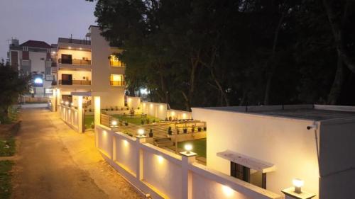 a building with lights on the side of it at night at Park View Yelagiri in Yelagiri