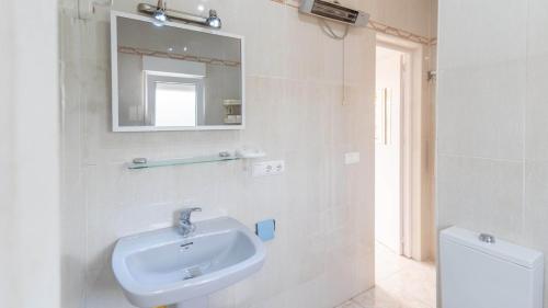 a bathroom with a sink and a mirror and a toilet at Villa Mariposas Torrox by Ruralidays in Torrox