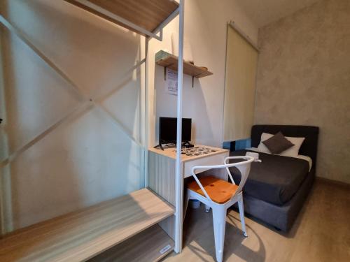 a small room with a desk with a computer and a couch at Sunway Paradise Home Staycation PH2120 SELF CHECK IN OUT in Subang Jaya