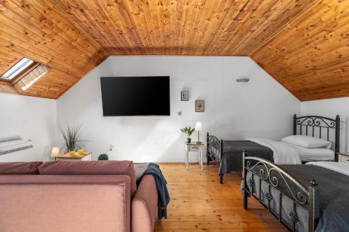 a bedroom with two beds and a flat screen tv at Hacienda Sylvia - secluded 4-bedroom villa with 45sqm heated pool in Studenci