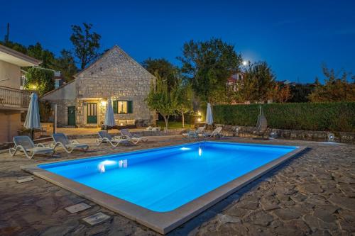 a swimming pool in the yard of a house at Hacienda Sylvia - secluded 4-bedroom villa with 45sqm heated pool in Studenci