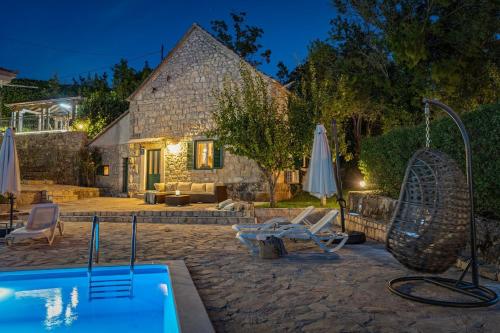 a villa with a swimming pool at night at Hacienda Sylvia - secluded 4-bedroom villa with 45sqm heated pool in Studenci