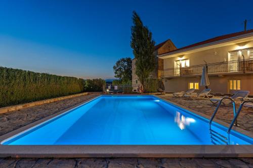 a swimming pool in the backyard of a villa at Hacienda Sylvia - secluded 4-bedroom villa with 45sqm heated pool in Studenci