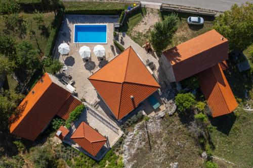 an overhead view of a house with an orange roof at Hacienda Sylvia - secluded 4-bedroom villa with 45sqm heated pool in Studenci
