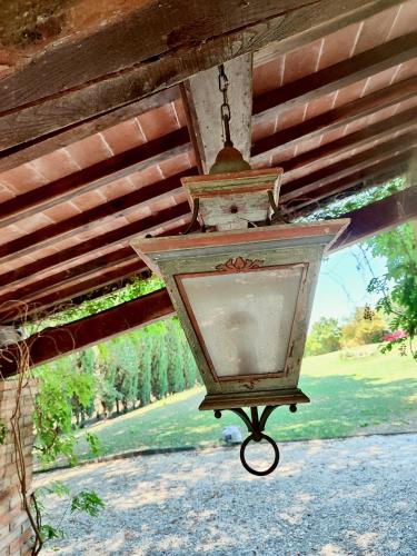 a lamp hanging from the ceiling of a house at The Monastery - St Antimo in Monterchi