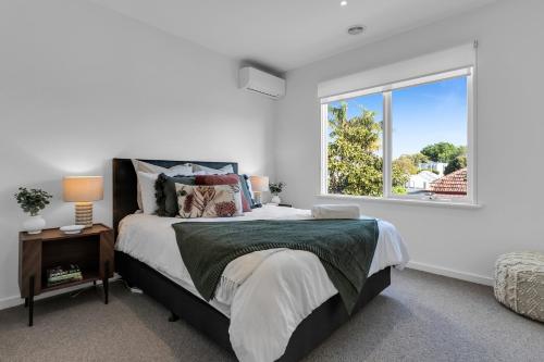 a bedroom with a large bed and a window at Bev's Retreat by Ready Set Stay in Melbourne