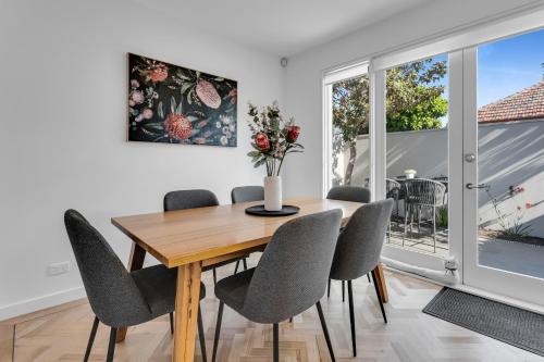 a dining room with a wooden table and chairs at Bev's Retreat by Ready Set Stay in Melbourne
