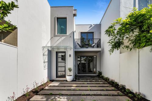 a white house with a walkway at Bev's Retreat by Ready Set Stay in Melbourne