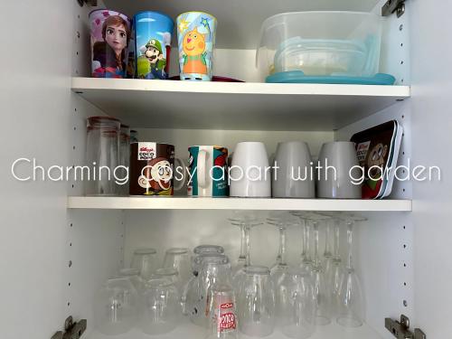 a cupboard filled with lots of clear glass jars at Charming cosy apart with garden free parking in Claye-Souilly
