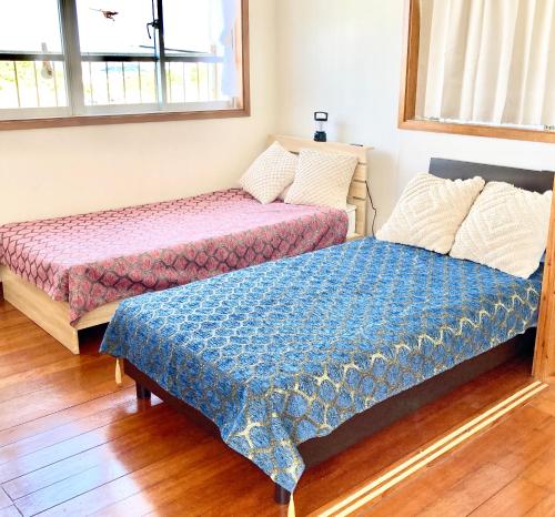 Ένα ή περισσότερα κρεβάτια σε δωμάτιο στο Piano & Resort Stay "Kohinoor Ginowan"