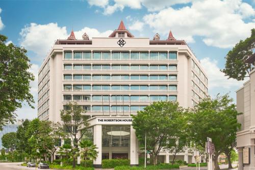 a white building with a clock on top of it at The Robertson House by The Crest Collection in Singapore