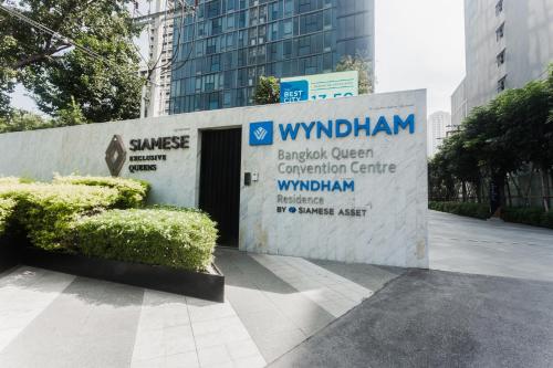 a sign for the switzerland entrance to a building at Wyndham Bangkok Queen Convention Centre in Bangkok