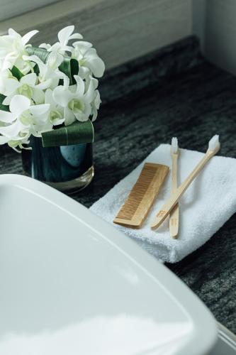 a table with a vase of white flowers and chopsticks at Centara Grand Hotel Osaka in Osaka