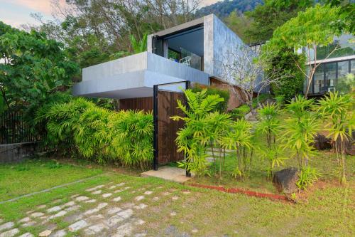a house on a hill with a garden at Romantic villa in the tropics near Kamala Beach in Kamala Beach