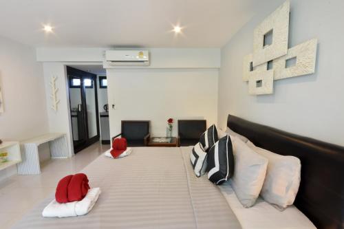 a bedroom with a large bed with red and white pillows at Villa Labaron in Koh Samui 